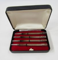 Set of four sterling silver enamelled bridge pencils, each engine-turned with rectangular terminal