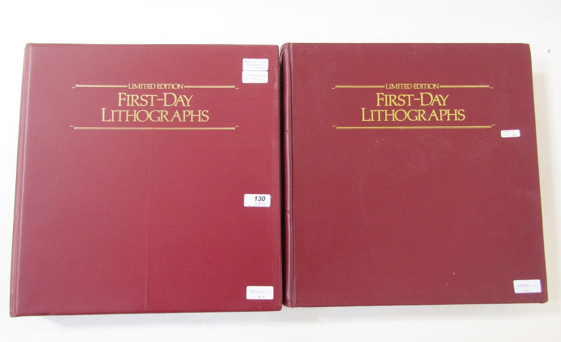 GB stamps: Two maroon folders of QEII philatelic lithographs; first of 27 commemoratives 1979-82,