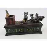 Reproduction cast iron cat and mouse money box, a 1977 coinage of Great Britain and Northern Ireland