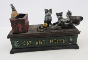 Reproduction cast iron cat and mouse money box, a 1977 coinage of Great Britain and Northern Ireland