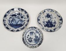 Two 18th century delft tin glazed blue and white dishes and a similar charger, the charger decorated