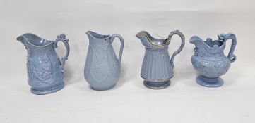 Four 19th century stoneware moulded relief jugs with pale blue glaze, one with scenes of children