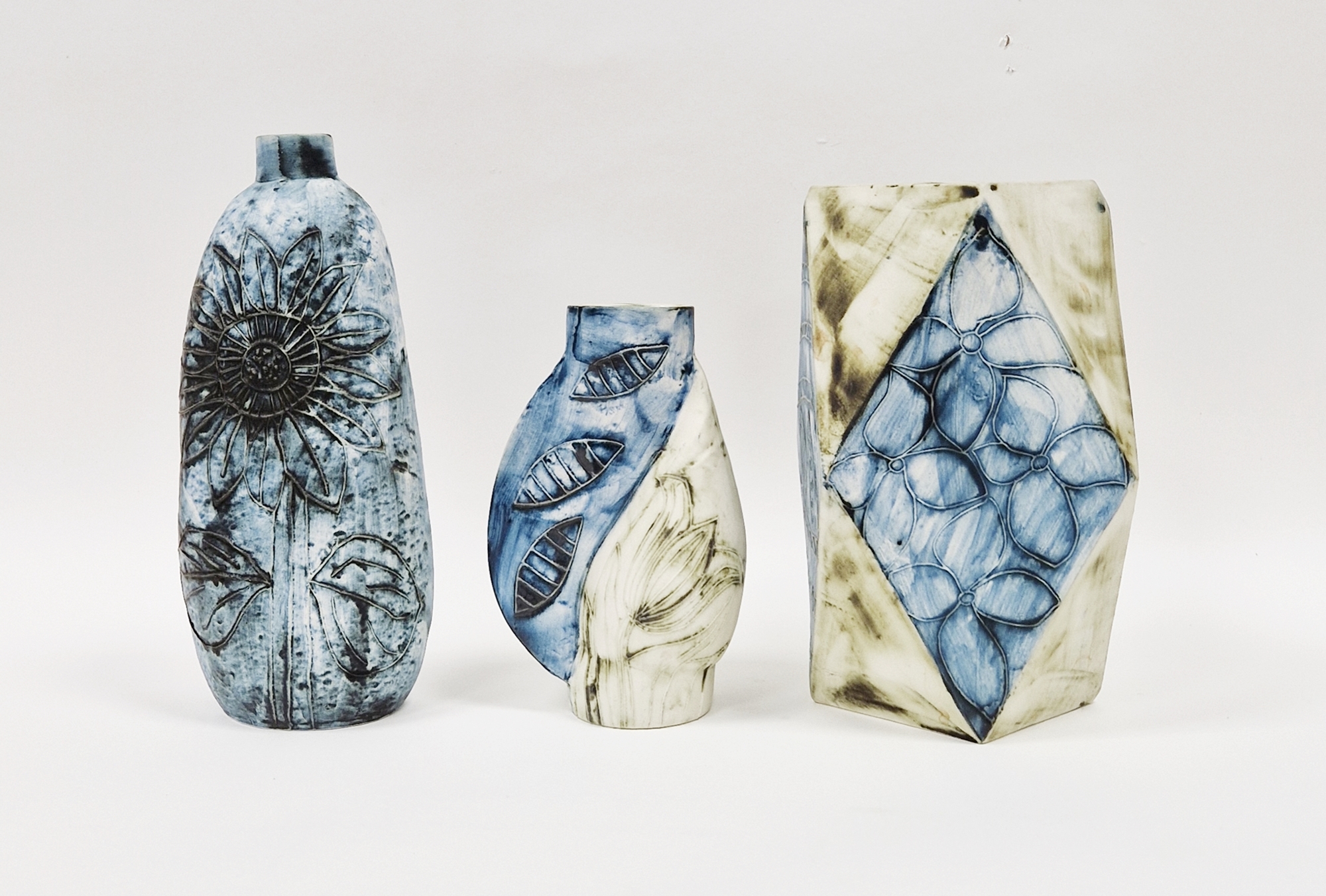 Three Carn Pottery vases by John Beusmans, with tube lined floral decoration, all signed and with