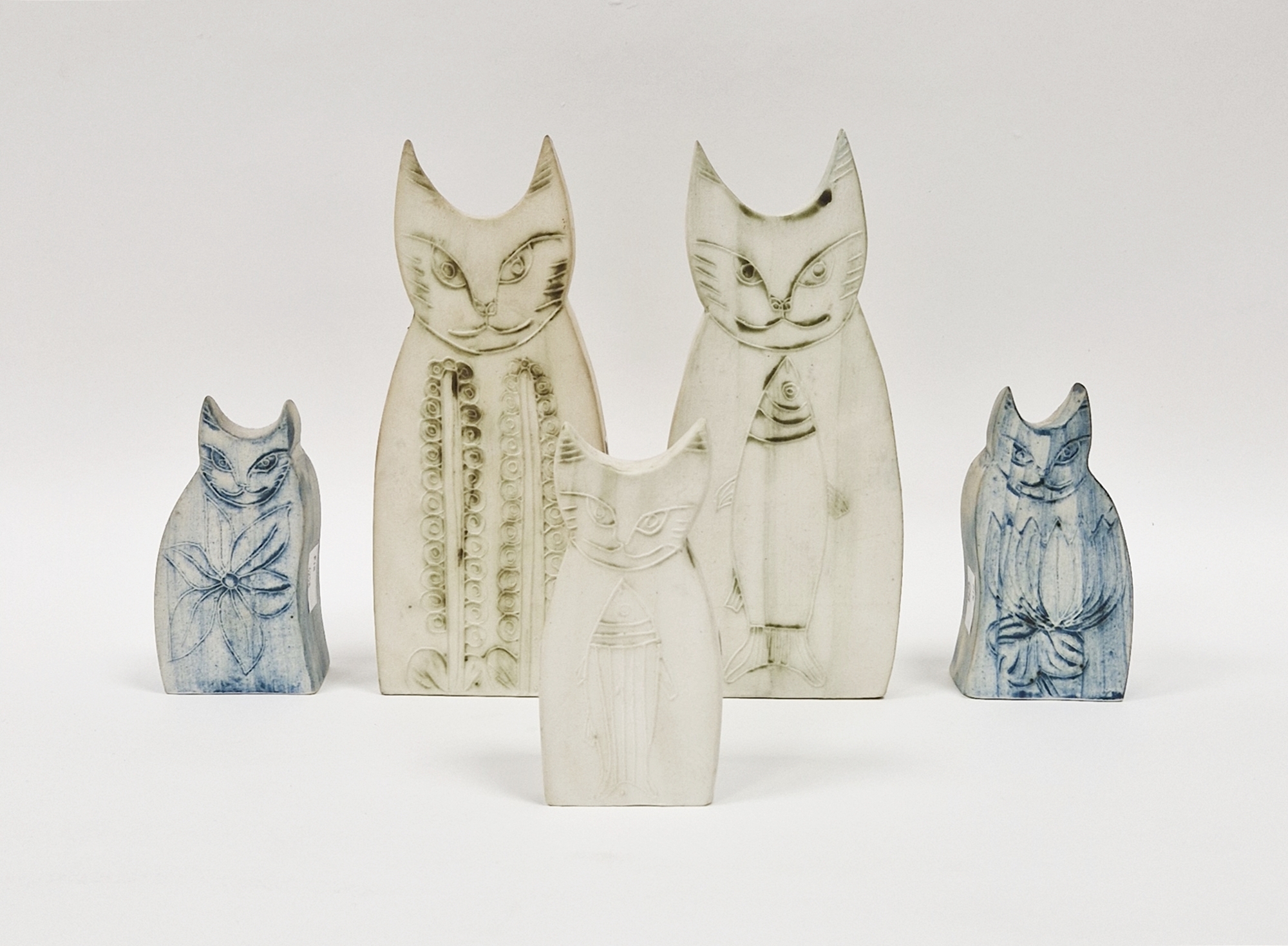 Five Carn Pottery models of cats by John Beusmans with tube lined decoration, signed and printed