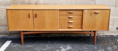 Mid century G-Plan teak Brasilia Range sideboard comprising a central bank of four drawers flanked