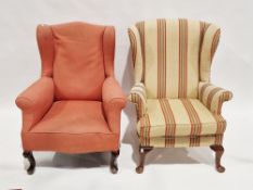 Mid 20th century wing back armchair upholstered in a striped fabric and raised on short cabriole