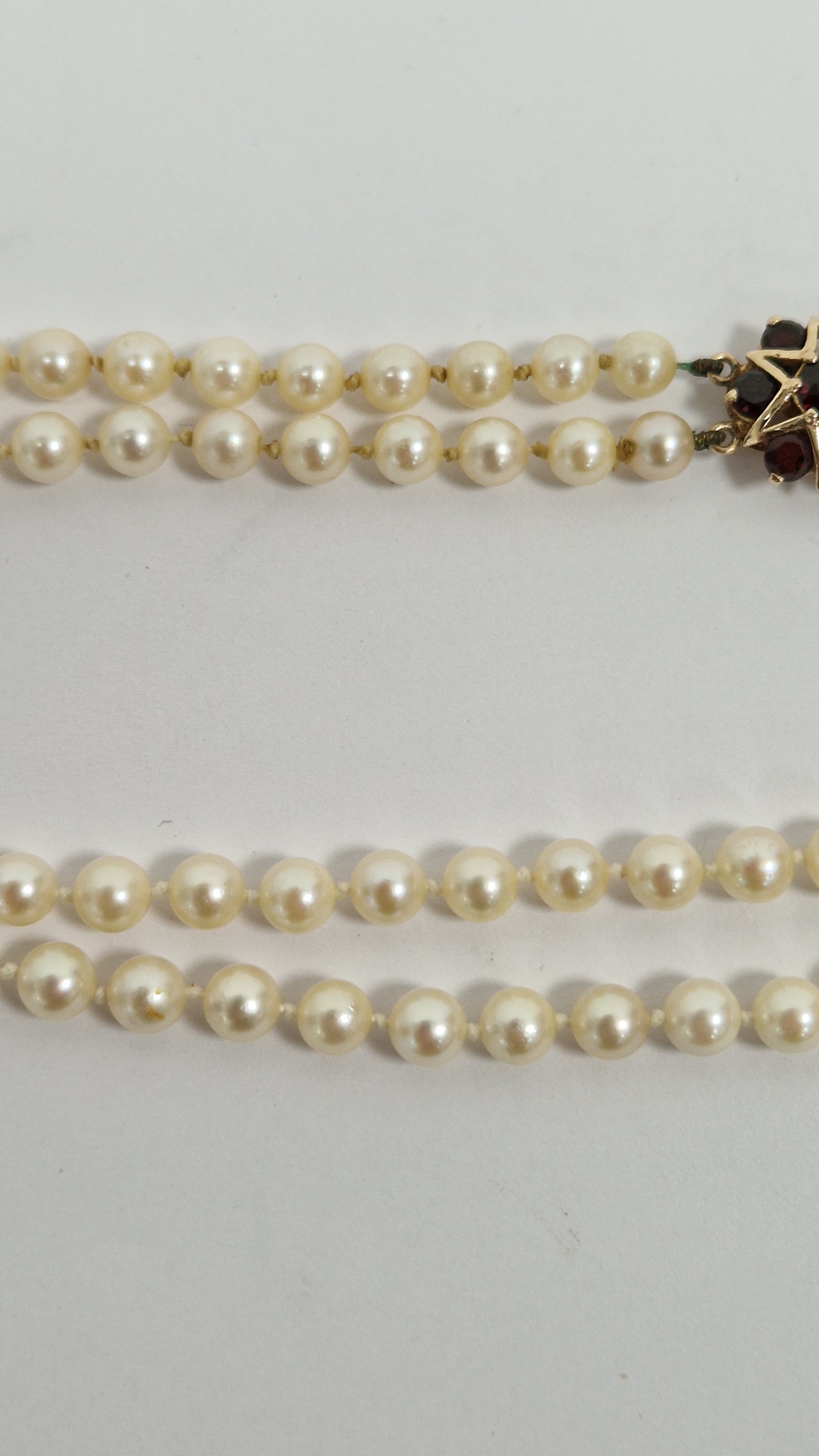 Double string of cultured pearls with 9ct gold and garnet set clasp, with star design, cased - Image 6 of 8