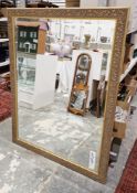 Large contemporary gilt framed mirror, the frame with moulded floral and foliate decoration, the