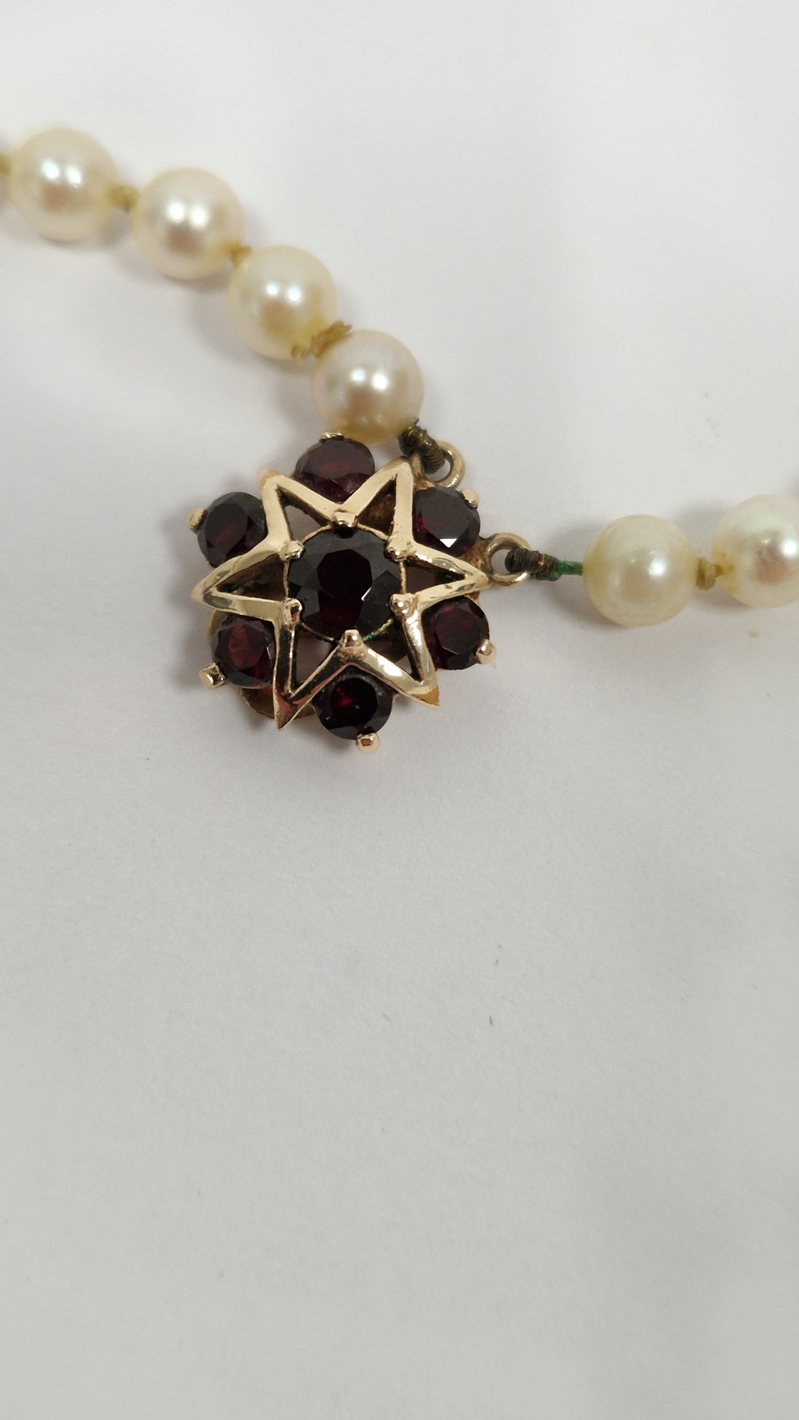 Double string of cultured pearls with 9ct gold and garnet set clasp, with star design, cased - Image 2 of 8