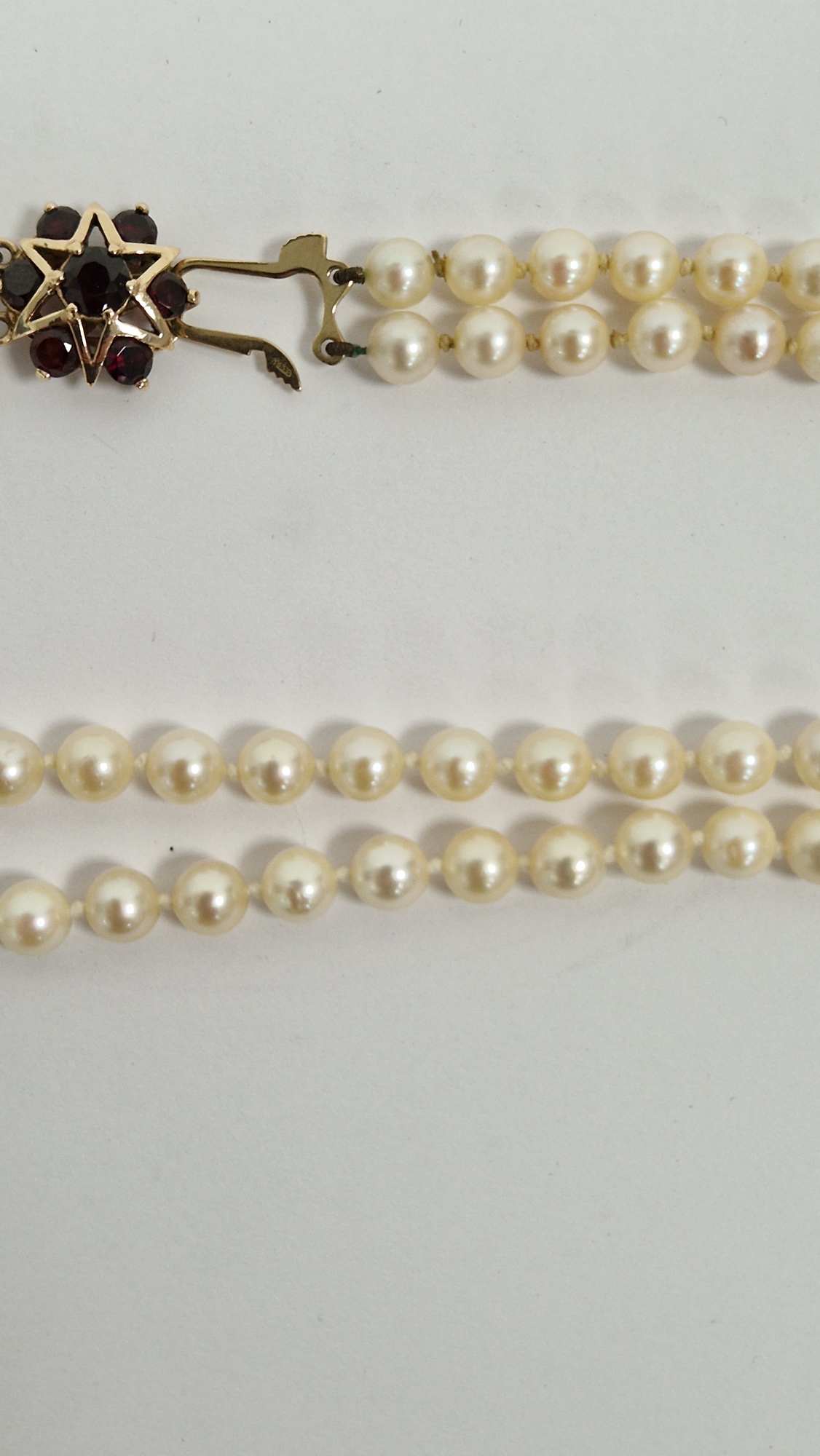 Double string of cultured pearls with 9ct gold and garnet set clasp, with star design, cased - Image 7 of 8