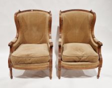 Pair of walnut framed bergere armchairs in the Louis XVI manner, with carved reeded scrolling arms