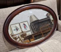 Early 20th century oval mahogany framed wall mirror with bevelled edge, 85cm x 60cm