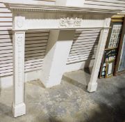 Two wooden fire place surrounds, one with central urn and acanthus leaf design and foliate panels to