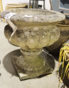 Reconstitued stone shallow urn-shaped planter on integral square form pedestal base