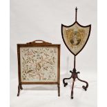 Early 19th century mahogany polescreen, the shield-shaped panel having a silk and painted embroidery