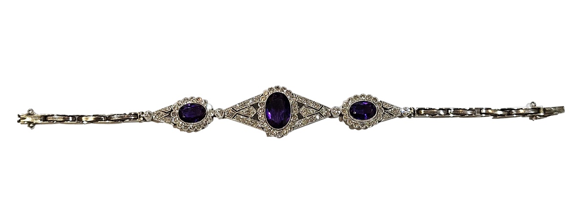 White metal articulated amethyst and diamond bracelet, the central oval mix cut amethyst