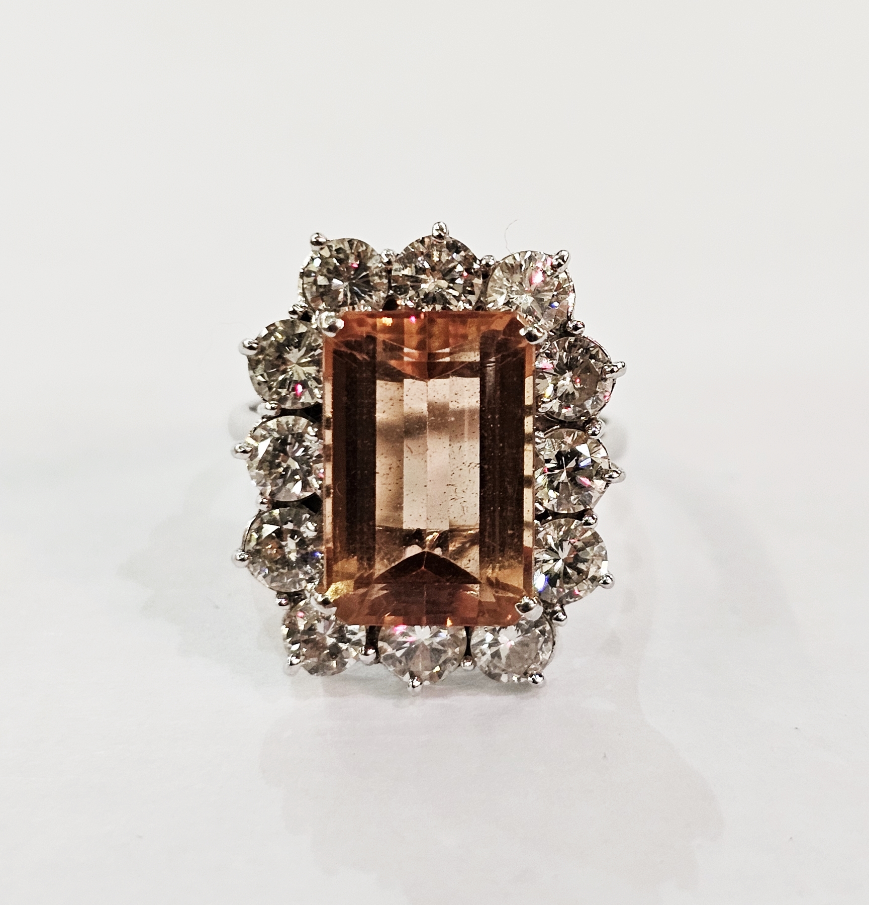 18ct gold dress ring set central peach topaz rectangular stone surrounded by diamonds, weight 7gms