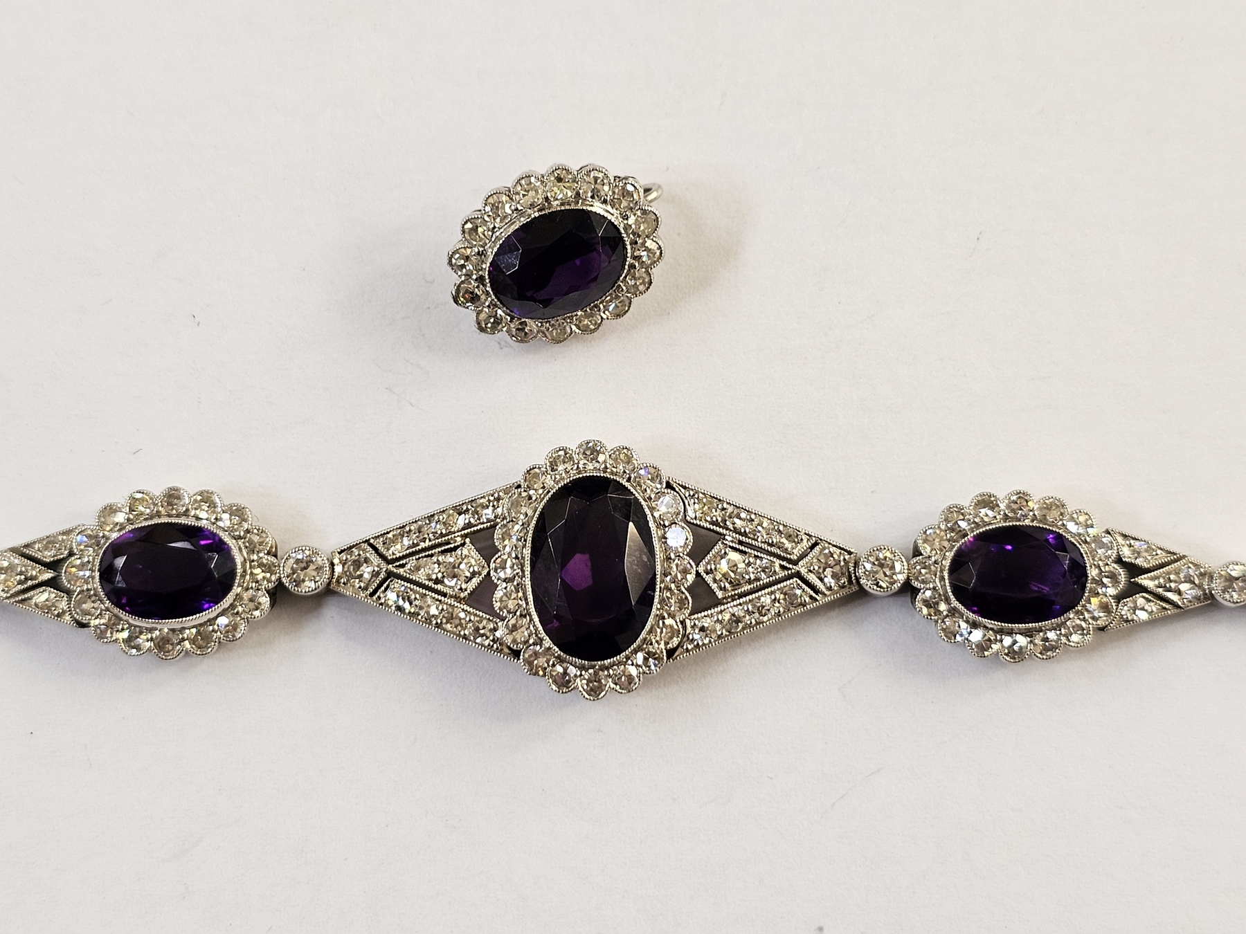 White metal articulated amethyst and diamond bracelet, the central oval mix cut amethyst - Image 2 of 2