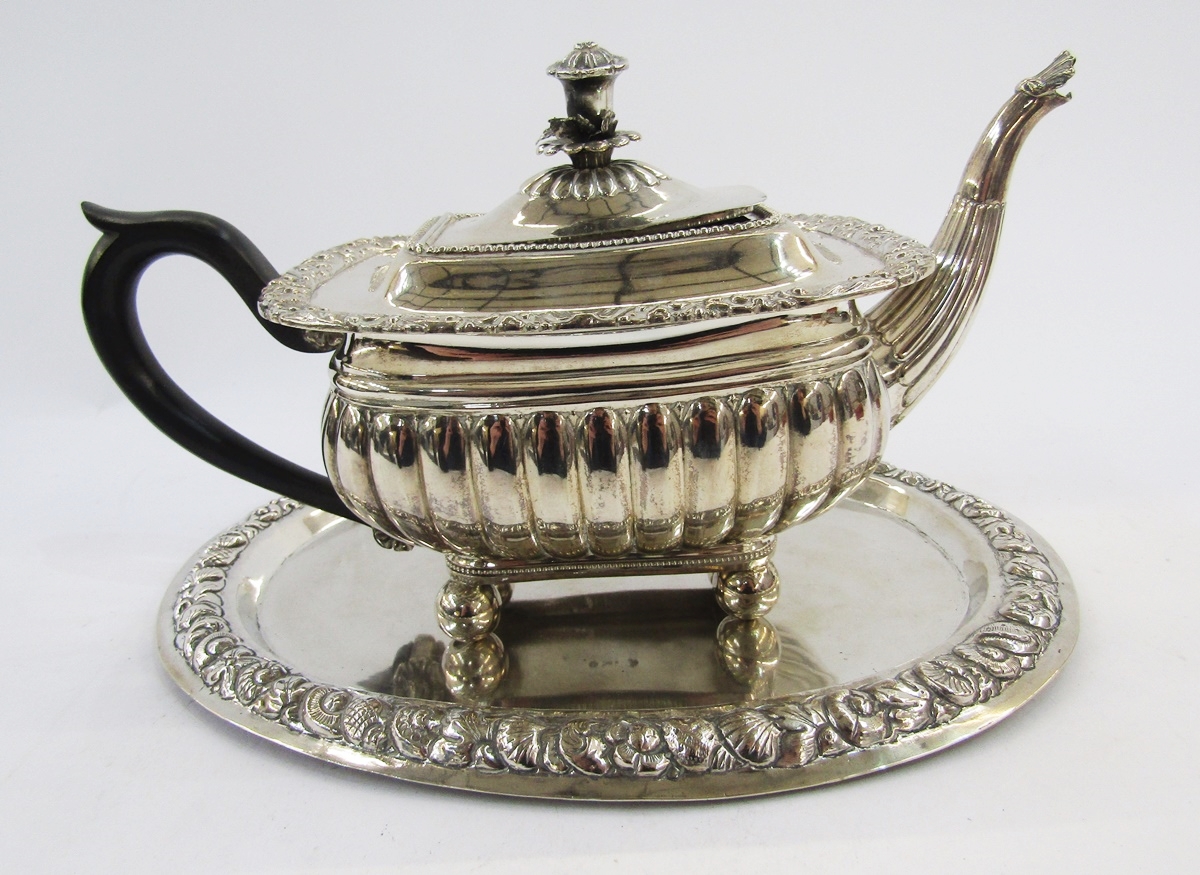 Silver plate teapot in the George III manner of rectangular squat form with flower finial, scrolling