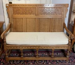 A light oak peg jointed Arts and Crafts movement period settle with cushion