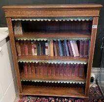 A late Victorian inlaid bookcase with green leather dust flaps
