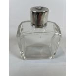 Silver topped scent bottle with dog embossed on the top dated 1930