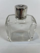 Silver topped scent bottle with dog embossed on the top dated 1930