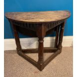 A 17th century oak credence table with a drop leaf side.