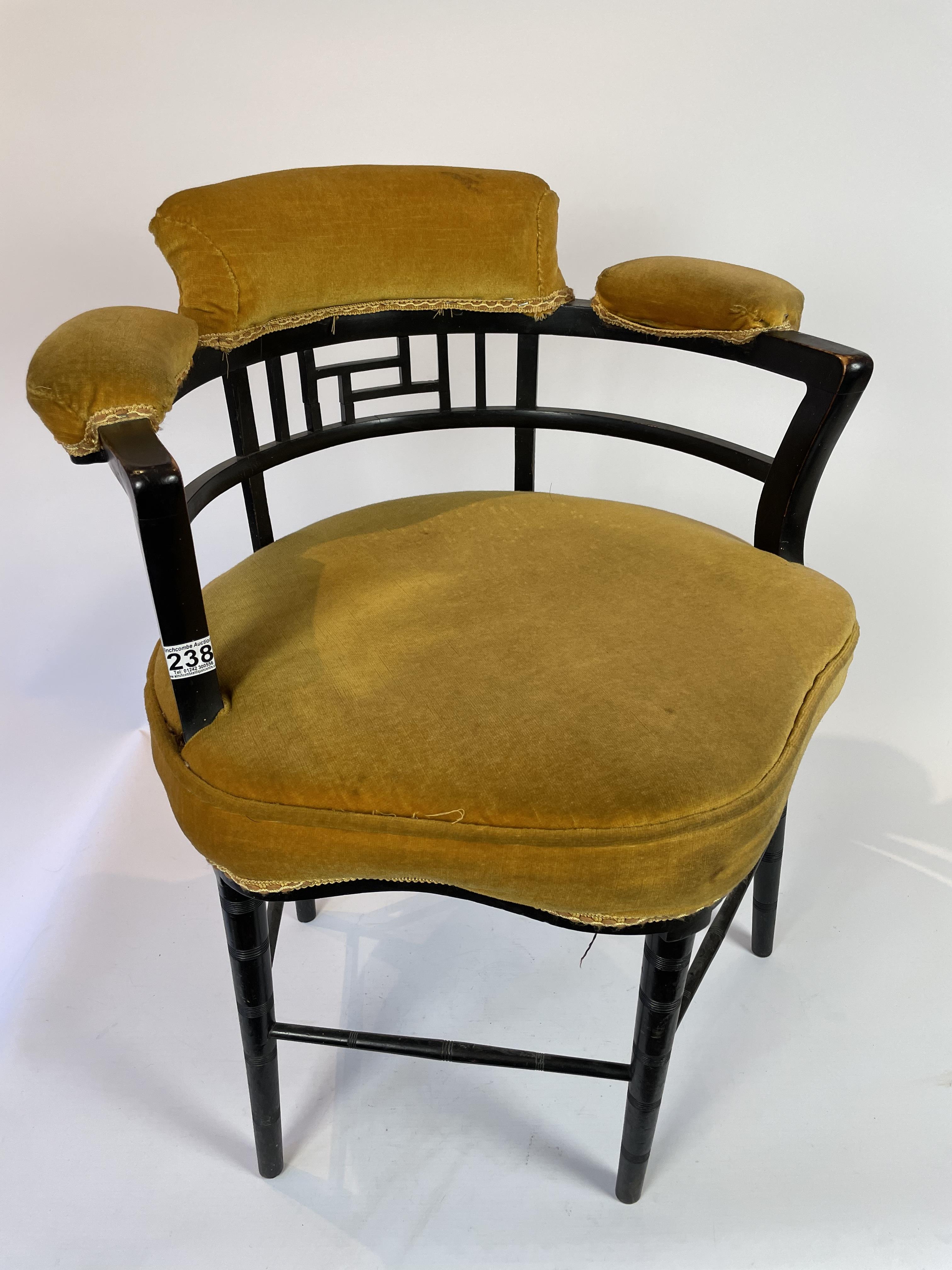 A late 19th centuryasthetic movement chair with padded seat, arms and back