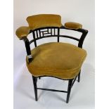 A late 19th centuryasthetic movement chair with padded seat, arms and back