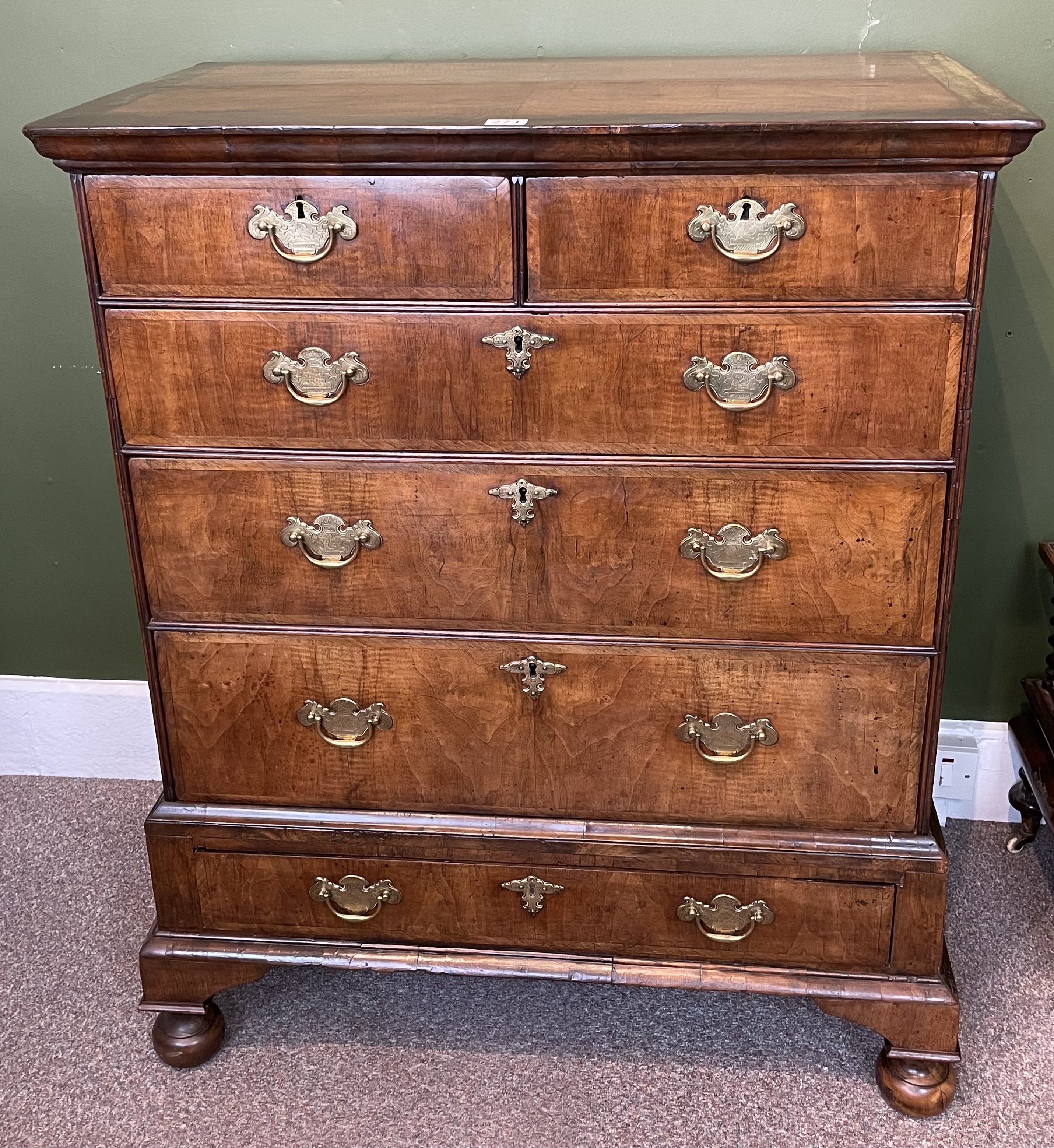 A Walnut Feather Banded Chest On Stand With Bun Feet