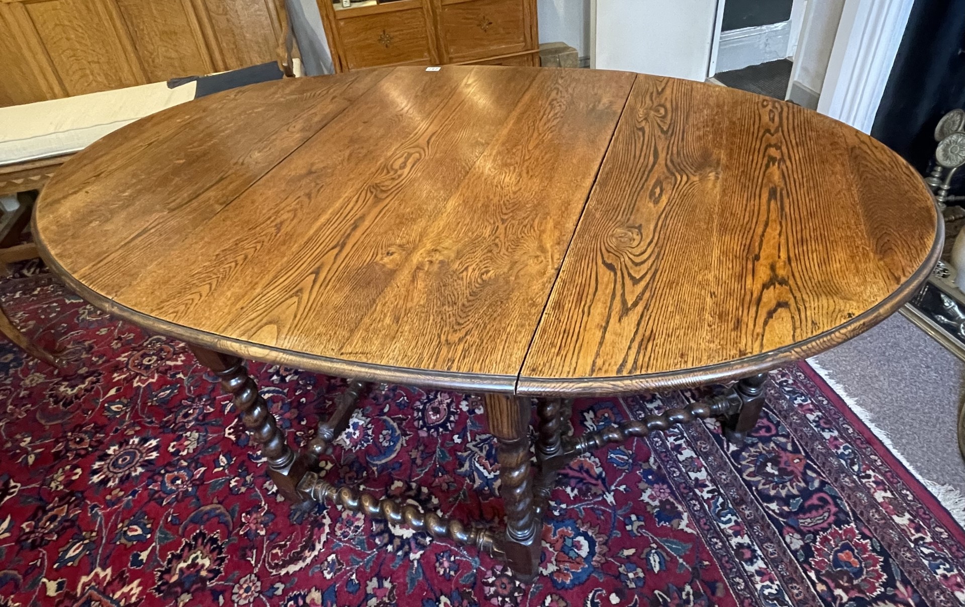 An antique oak drop leaf barley twist table