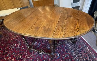 An antique oak drop leaf barley twist table