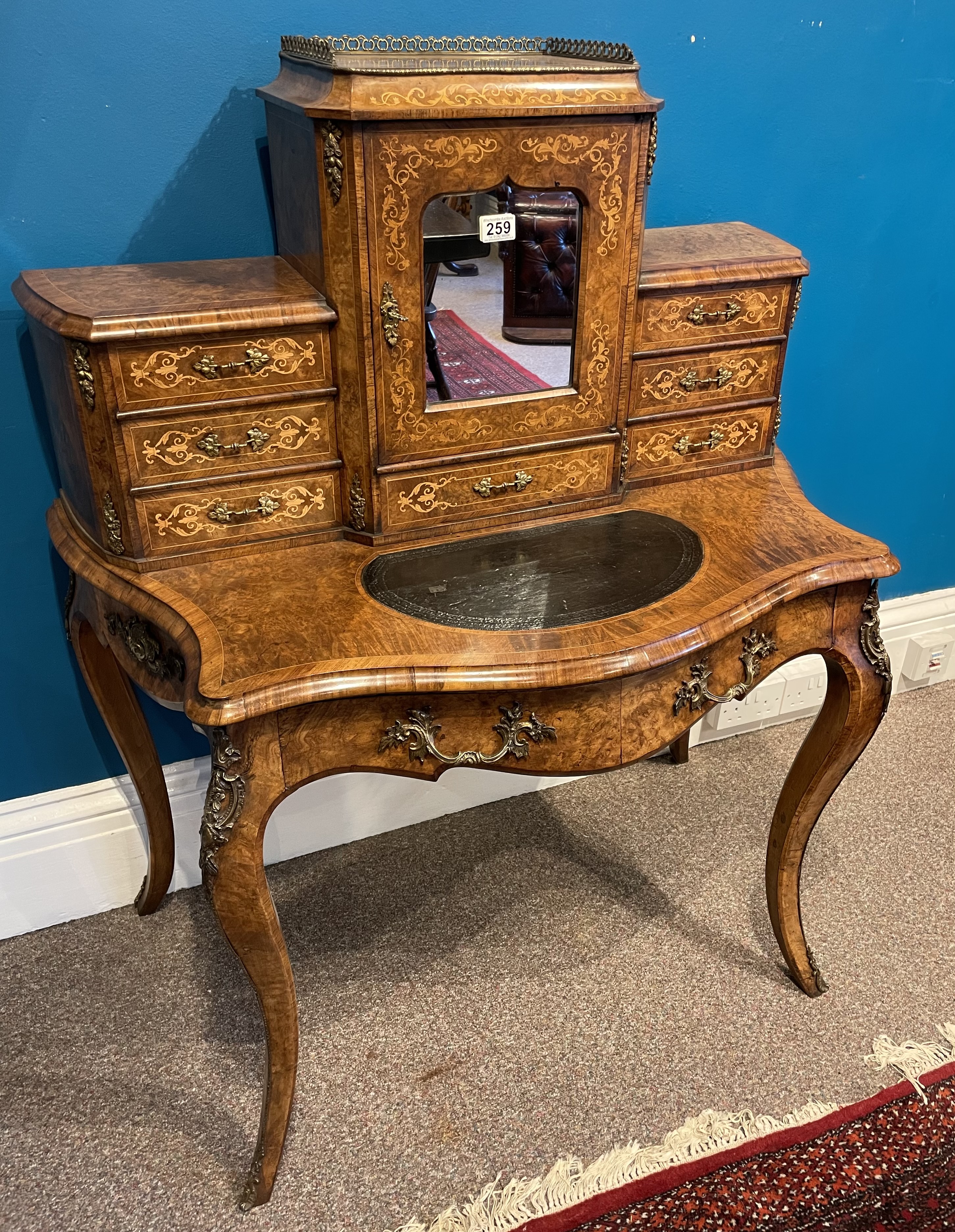 A 19th century French Walnut 'Bon-De-Jour' desk with extensive marquetry, leather insert.