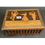 Treen box with inlaid dancers and hidden compartment beneath.