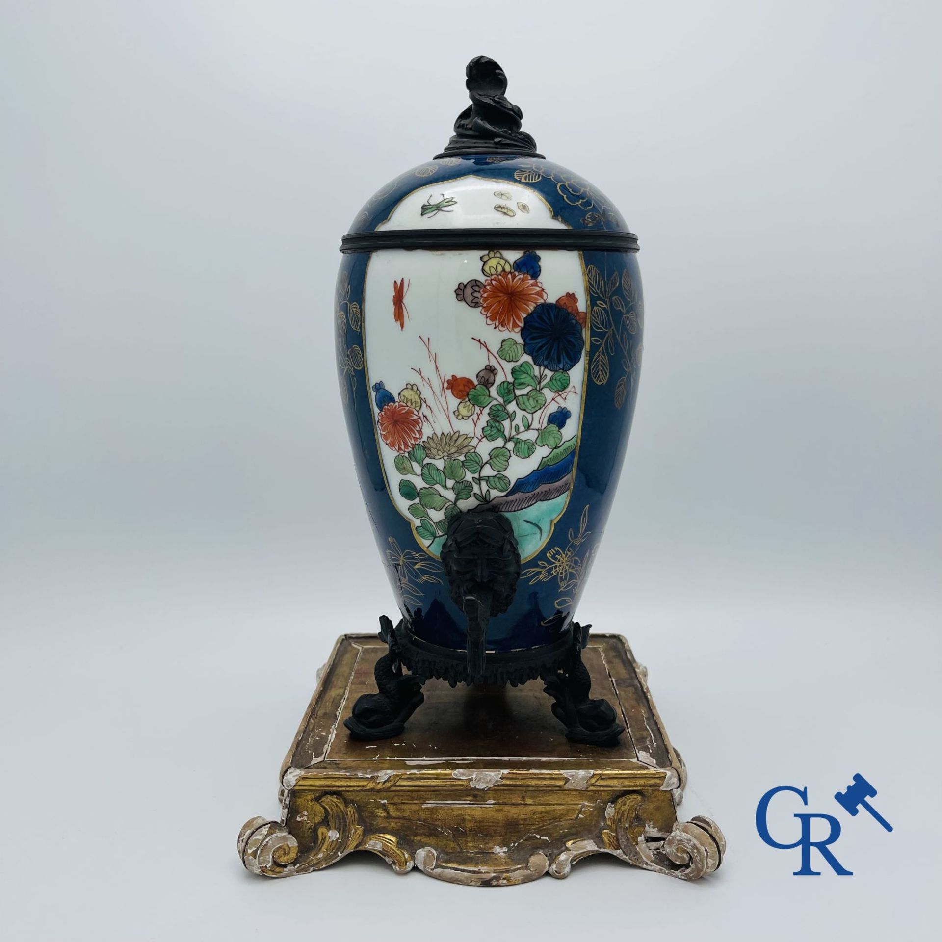 A porcelain table fountain with bronze fittings.