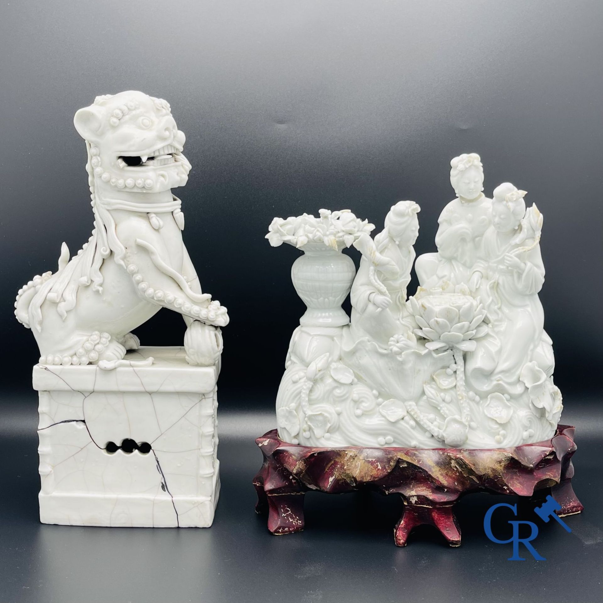 Chinese porcelain: A Buddhist lion and a group in blanc de Chine.