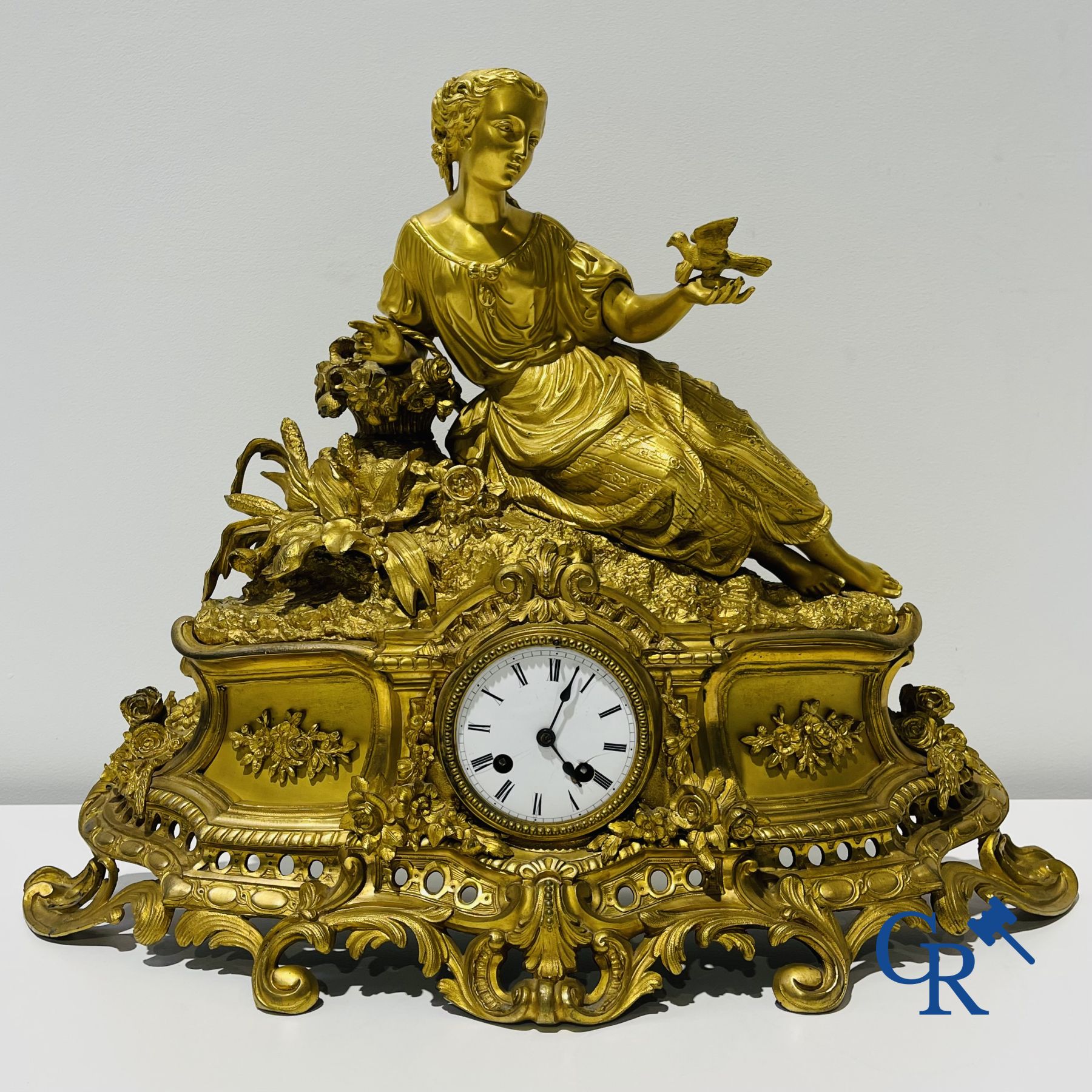 Bronze gilded clock with a romantic performance. 19th century.