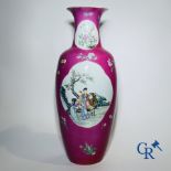 Chinese porcelain: A fine famille rose vase decorated on a red ruby background in sgraffito techniqu