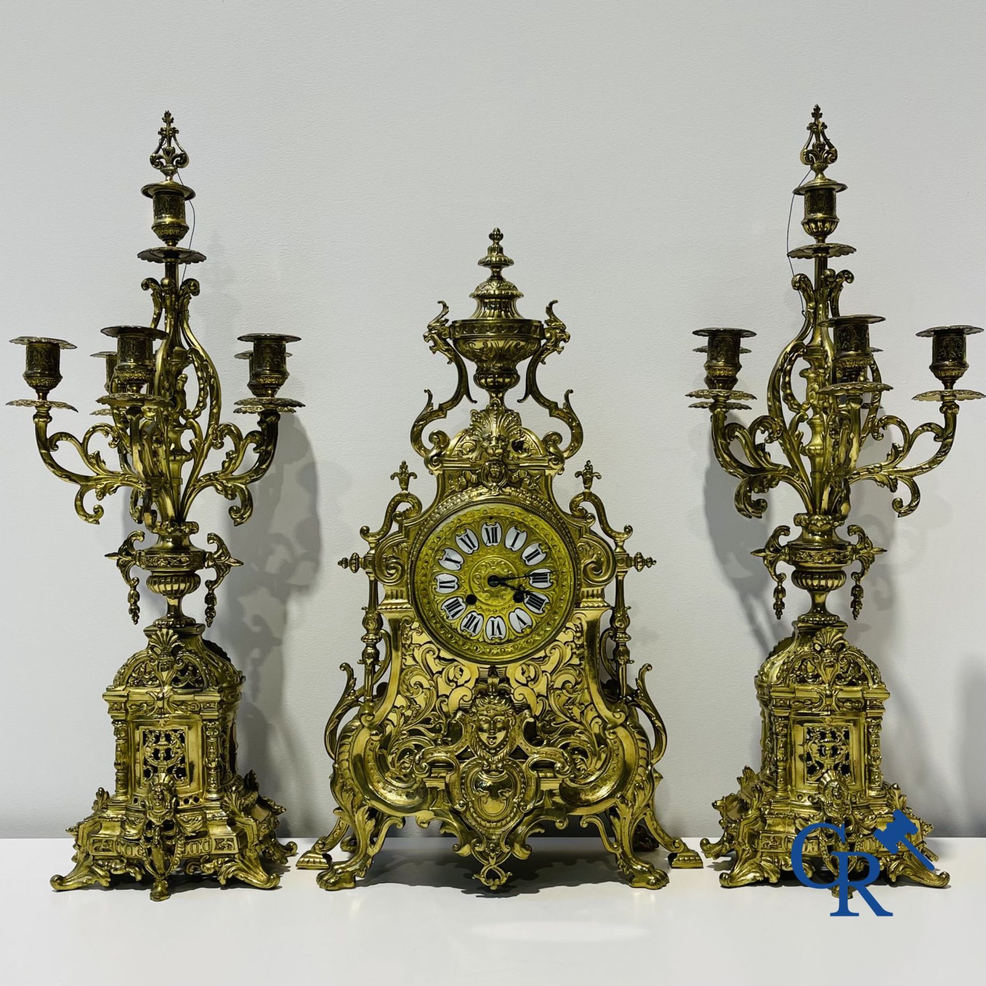A three-part bronze fireplace clockset in Renaissance style and 2 painted tin and bronze pendant clo