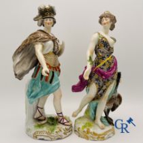 A pair of polychrome porcelain figures in the manner of Meissen.