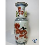 Chinese porcelain: A Chinese famille rose vase with a decor of Buddhist lions, phoenixes, birds and 