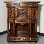 Furniture: A finely carved walnut credence in neo renaissance style with marble inlay.