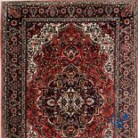 Oriental carpets: Iran. Large Persian hand-knotted carpet with floral decor.