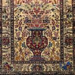 Oriental carpets. Iran. Persian carpet with a flower vase, birds and rabbits in a floral decor.