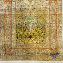 Oriental carpets: An exceptionally signed carpet in silk and gold thread with verses and a floral de