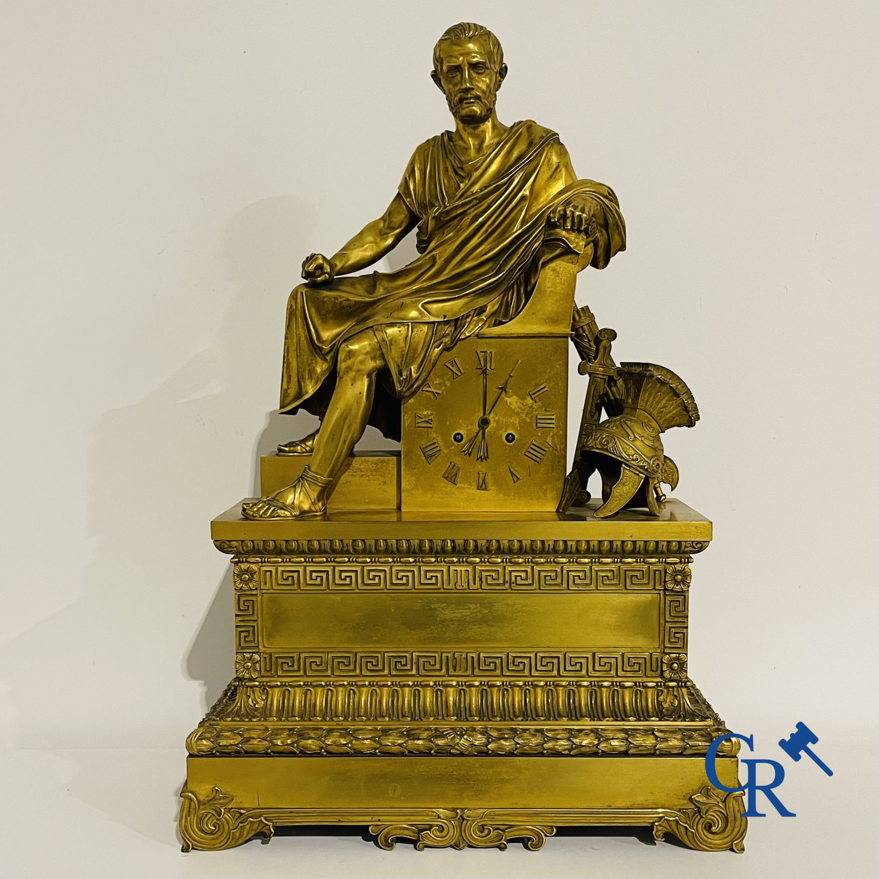 Imposing fire-gilded empire pendulum depicting a seated Roman emperor.