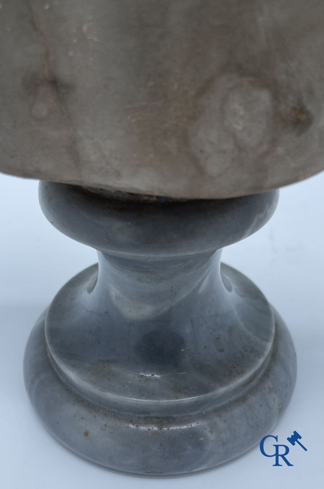 A bust in terre cuite on a blue gray marble pedestal. 19th century. - Image 6 of 8