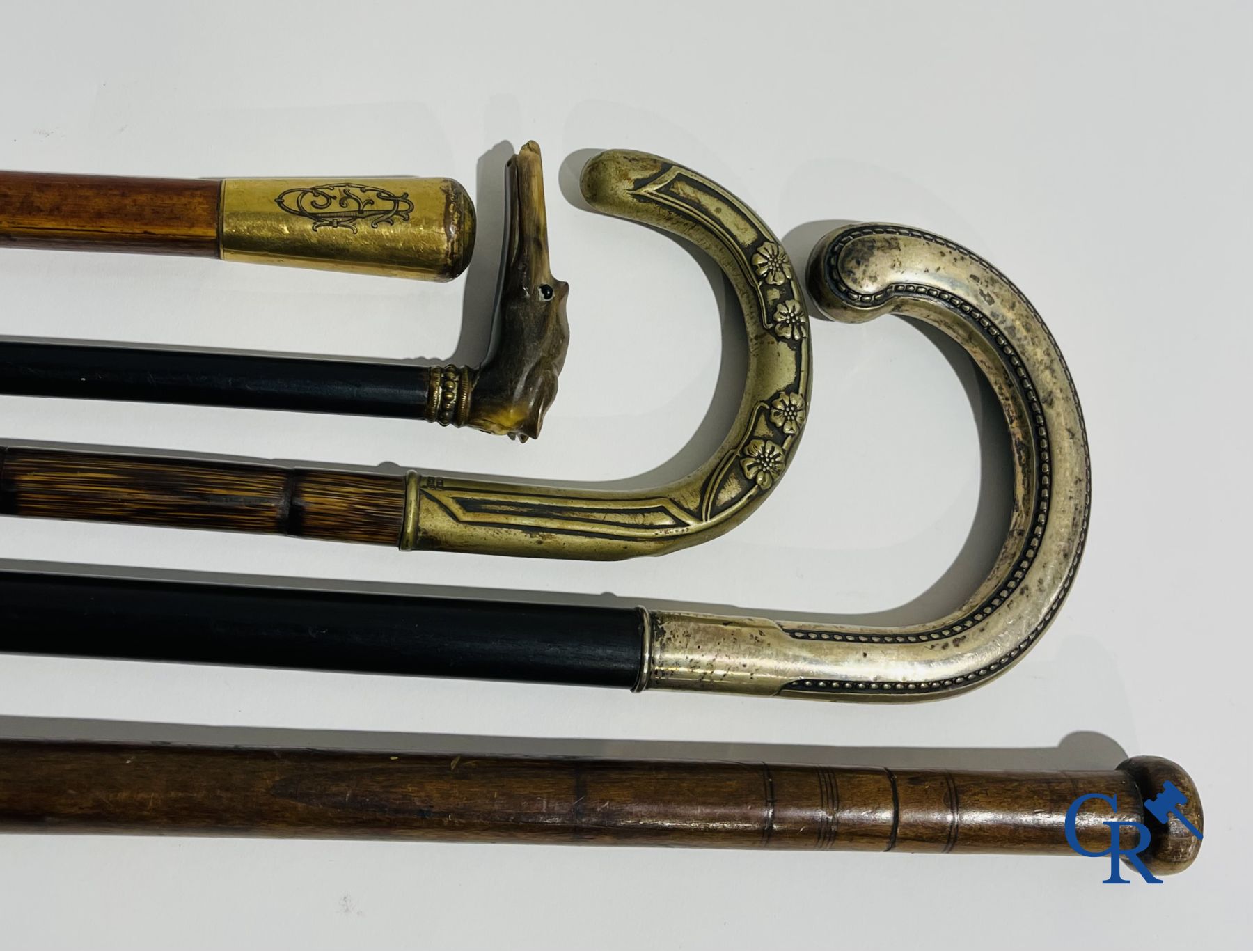 5 walking sticks including 1 with silver handle.