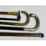 5 walking sticks including 1 with silver handle.